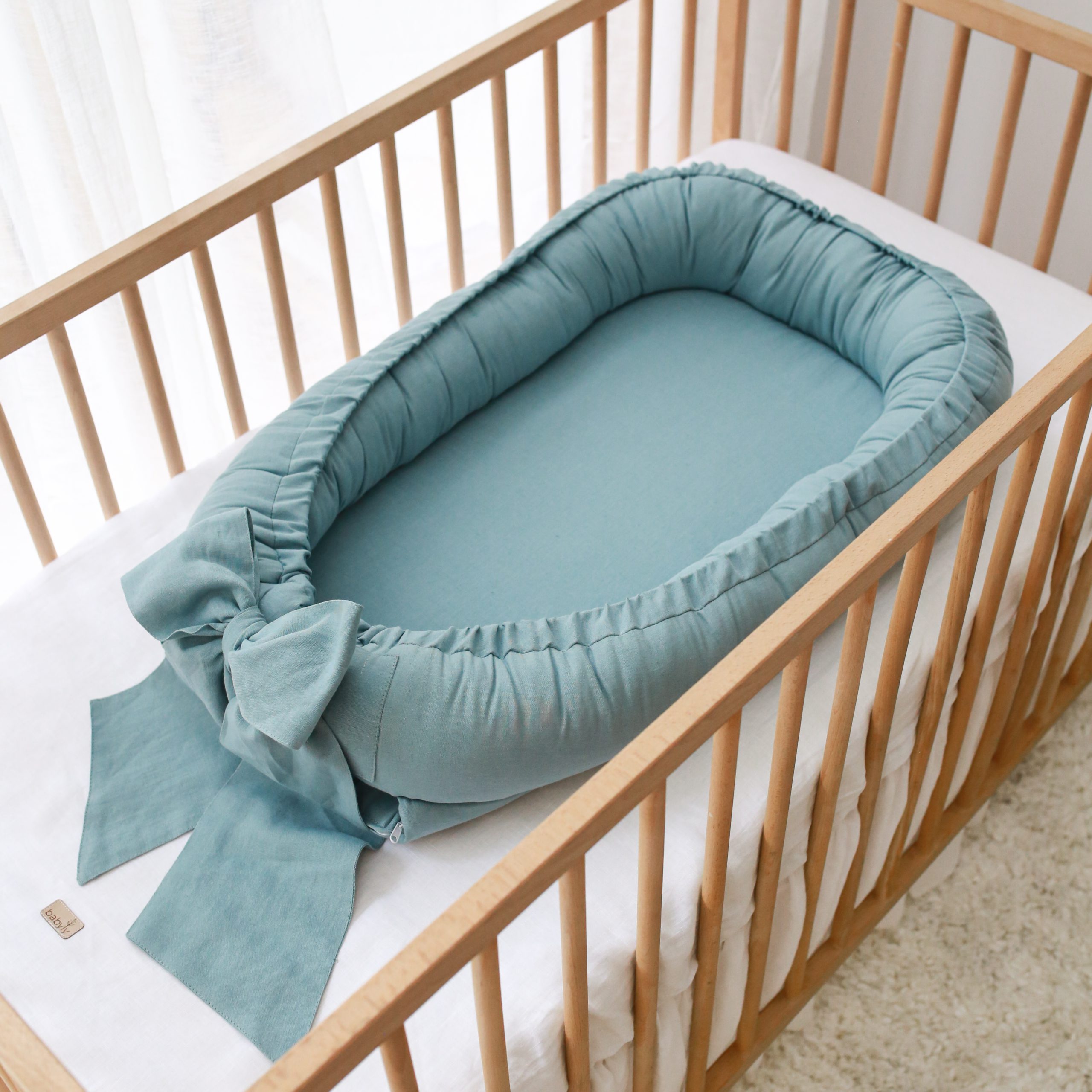 Linen babynest with bow sea blue